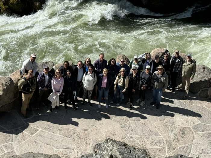 A leadership offsite group above the rapids in Yellowstone
